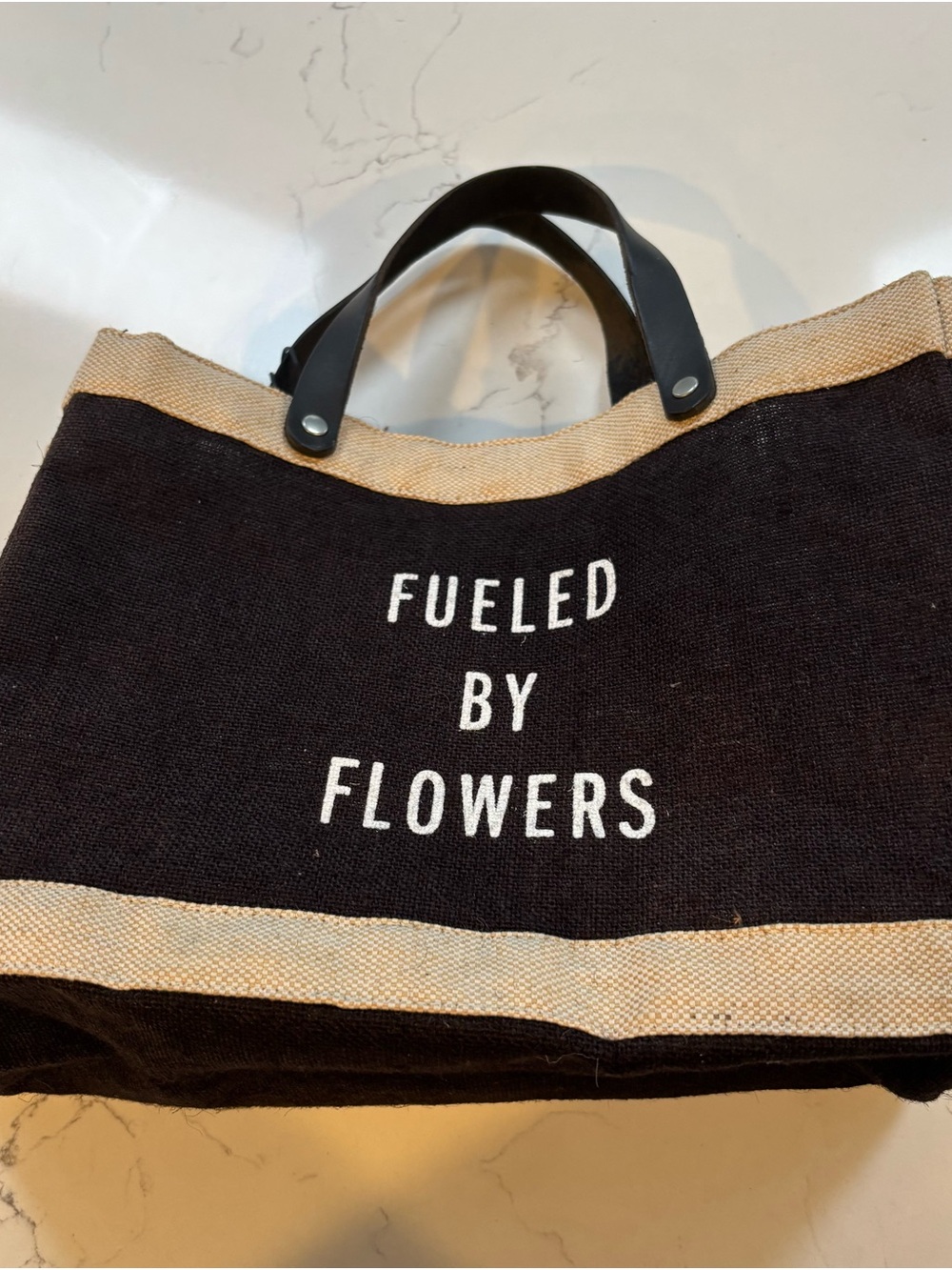 Black Canvas Tote with 'Fueled by Flowers' Slogan